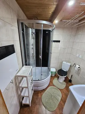 a bathroom with a tub and a toilet and a sink at Domki Mosorczyk in Zawoja