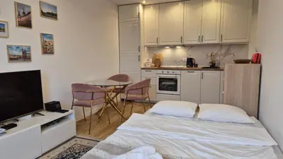 a bedroom with a bed and a kitchen with a table at Wawel View 31, Kazimierz # Netflix # Air Conditioning # in Kraków