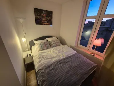 a small bed in a bedroom with a window at Wawel View 31, Kazimierz # Netflix # Air Conditioning # in Kraków