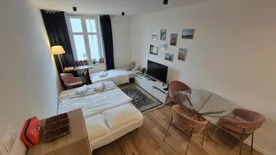 a living room with a bed and a table at Wawel View 31, Kazimierz # Netflix # Air Conditioning # in Kraków