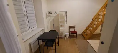a small room with a table and chairs and a window at The Augustianska Getaway in Kraków