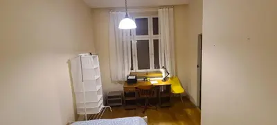 a small room with a desk and a window at The Augustianska Getaway in Kraków