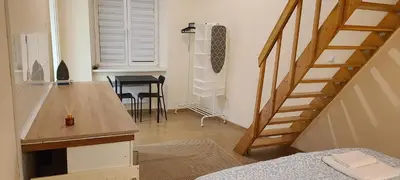 a small room with a staircase and a table at The Augustianska Getaway in Kraków