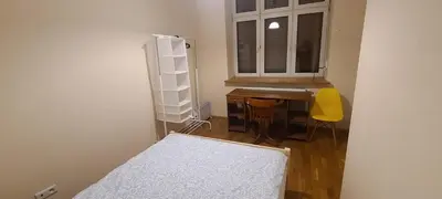 a bedroom with a desk and a sink and a window at The Augustianska Getaway in Kraków