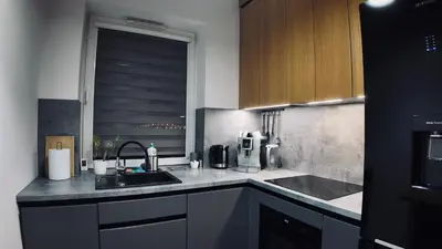 a kitchen with a sink and a microwave at Płaszowska Apartments in Kraków