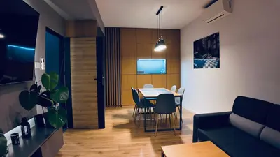 a living room with a table and a couch at Płaszowska Apartments in Kraków