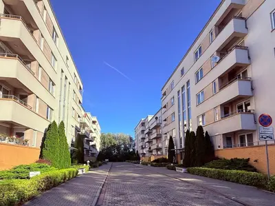 an empty street in front of apartment buildings at Płaszowska Apartments in Kraków
