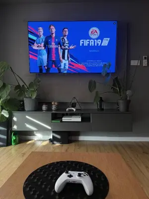 a living room with a tv and a video game controller at Płaszowska Apartments in Kraków