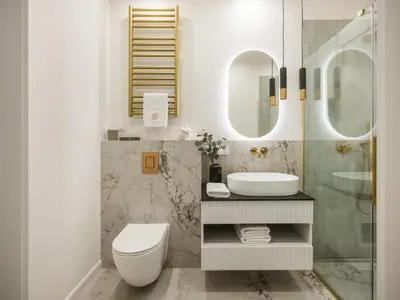 a bathroom with a toilet and a sink and mirrors at Astor Residence - Fragola Apartments in Kraków