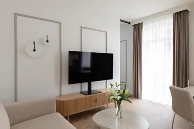 a living room with a flat screen tv on a wall at Native Apartments Prądnicka 48 in Kraków