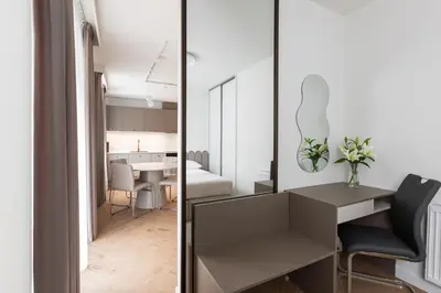 a small apartment with a mirror and a desk and a dining room at Native Apartments Prądnicka 48 in Kraków