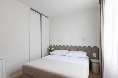 a bedroom with a large bed with white sheets at Native Apartments Prądnicka 48 in Kraków