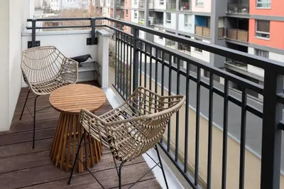 a balcony with two chairs and a table at Native Apartments Prądnicka 48 in Kraków