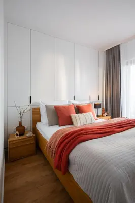 a bedroom with a large bed with orange and white pillows at Apartamenty Lew Invest, Stare Miasto, Bezpłatny parking in Kraków