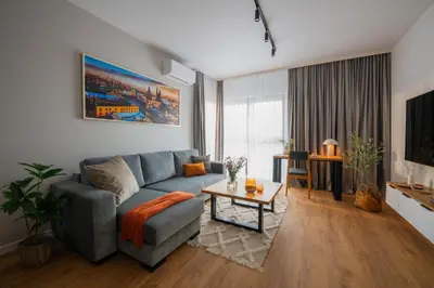 a living room with a couch and a bedroom at Apartamenty Lew Invest, Stare Miasto, Bezpłatny parking in Kraków