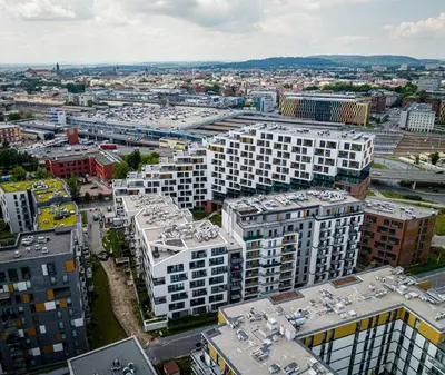 a balcony with a table and a view of the city at Apartamenty Lew Invest, Stare Miasto, Bezpłatny parking in Kraków