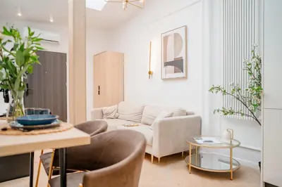 a living room with a couch and a table at Strzelecka Boutique Apartments in Kraków