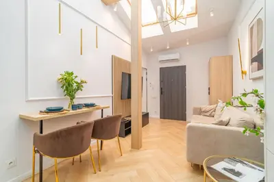 a living room with a couch and a table at Strzelecka Boutique Apartments in Kraków