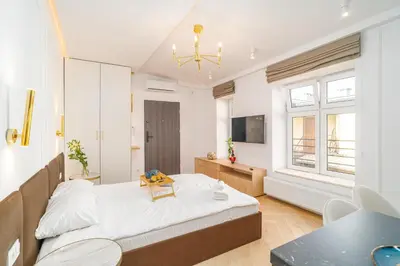 a bedroom with a bed and a table in it at Strzelecka Boutique Apartments in Kraków