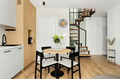 a kitchen and dining room with a table and chairs at Berka 12 - Quiet Two-Level Apartment in Kraków