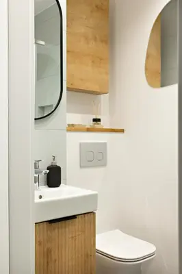 a bathroom with a sink and a mirror at Berka 12 - Quiet Two-Level Apartment in Kraków