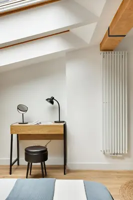 a desk in a bedroom with a bed and a lamp at Berka 12 - Quiet Two-Level Apartment in Kraków
