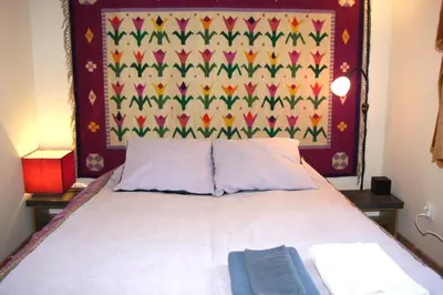 a bedroom with a bed with a colorful head board at Arras Studio with Wawel Castle view, WiFi in Kraków