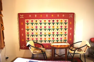 a table and chairs next to a wall with a pattern at Arras Studio with Wawel Castle view, WiFi in Kraków
