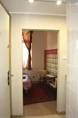 a door leading into a room with a table at Arras Studio with Wawel Castle view, WiFi in Kraków