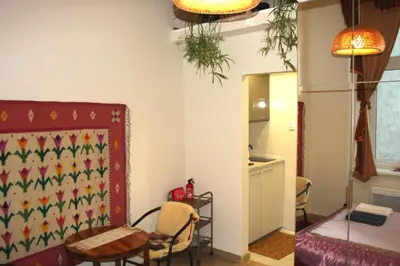 a room with a table and chairs and a kitchen at Arras Studio with Wawel Castle view, WiFi in Kraków