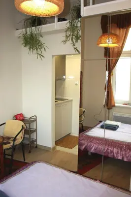 a room with a mirror and a bed and a table at Arras Studio with Wawel Castle view, WiFi in Kraków