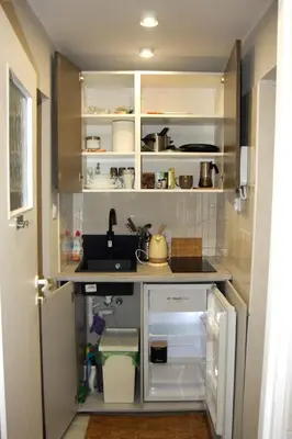 a small kitchen with a sink and a counter at Arras Studio with Wawel Castle view, WiFi in Kraków