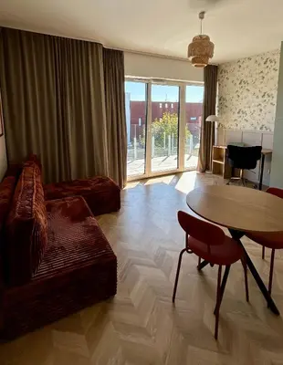 a living room with a table and a dining room at Stylowe studio z tarasem in Kraków