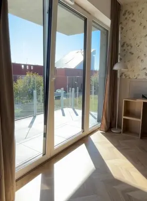 a room with a large sliding glass door at Stylowe studio z tarasem in Kraków