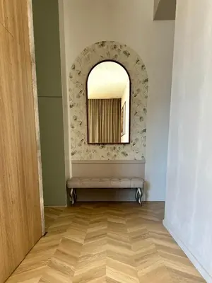 a hallway with a mirror and a bench in a room at Stylowe studio z tarasem in Kraków