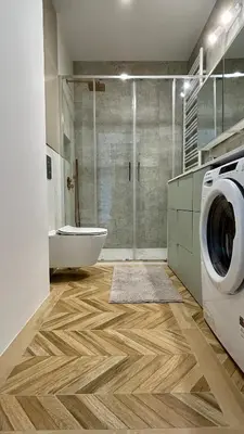 a bathroom with a washing machine and a shower at Stylowe studio z tarasem in Kraków