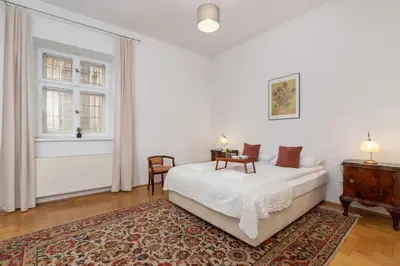 a white bedroom with a bed and a dresser at Heart of the City Apartments Market Square Cracow by Noclegi Renters in Kraków