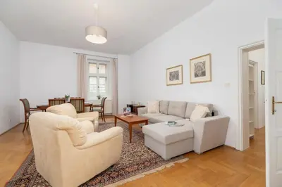 a living room with white furniture and a table at Heart of the City Apartments Market Square Cracow by Noclegi Renters in Kraków