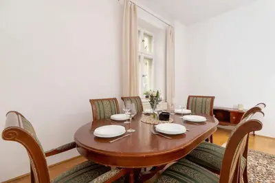 a dining room with a wooden table and chairs at Heart of the City Apartments Market Square Cracow by Noclegi Renters in Kraków