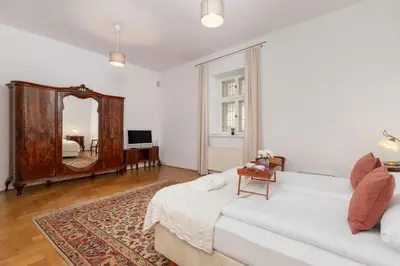 a living room with a white couch and a mirror at Heart of the City Apartments Market Square Cracow by Noclegi Renters in Kraków
