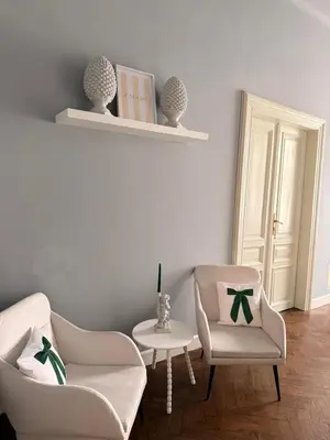 a living room with two chairs and a table at Two Paws Apartment in Kraków