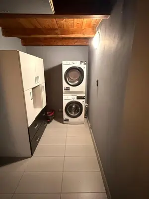 a washer and dryer in a small room at Two Paws Apartment in Kraków