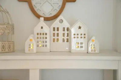 a shelf with three white toy houses on it at Hygge Beskid in Lachowice