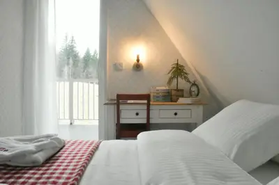 a bedroom with two white beds and a window at Hygge Beskid in Lachowice