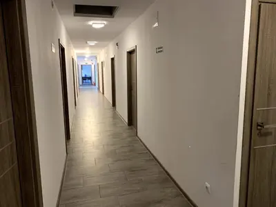 a hallway with white walls and a tile floor at Kwatery Smroków in Smroków