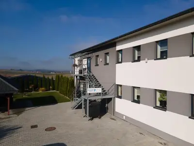 an external view of a building with a fire escape at Kwatery Smroków in Smroków