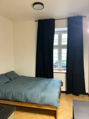 a bedroom with a bed and a window at Cozy Studio near Central Station Krakow in Kraków