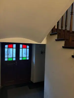 a hallway with a door with stained glass windows at Cozy Studio near Central Station Krakow in Kraków