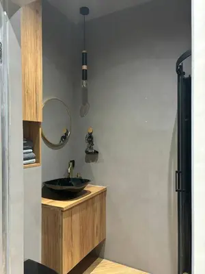 a bathroom with a black sink and a mirror at Cozy Studio near Central Station Krakow in Kraków