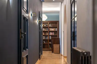 a hallway with a door leading to a library at Świętej Gertrudy Chic Apartment by BookingHost in Kraków